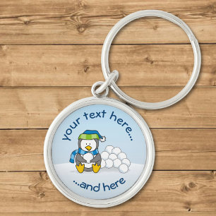 Llavero Pingüino pequeño sentado con bolas de nieve