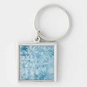 Llavero plumas azules abstractas y copos de nieve