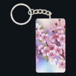 Llavero Sakura rosa sobre fondo de pintura<br><div class="desc">Dibujado artísticamente,  rama de rosa,  flores de cerezo sobre fondo pintoresco,  texturizado,  pintado con pintura blanca,  rosa y azul. Pink Sakura</div>