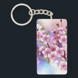 Llavero Sakura rosa sobre fondo de pintura<br><div class="desc">Dibujado artísticamente,  rama de rosa,  flores de cerezo sobre fondo pintoresco,  texturizado,  pintado con pintura blanca,  rosa y azul. Pink Sakura</div>