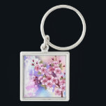 Llavero Sakura rosa sobre fondo de pintura<br><div class="desc">Dibujado artísticamente,  rama de rosa,  flores de cerezo sobre fondo pintoresco,  texturizado,  pintado con pintura blanca,  rosa y azul. Pink Sakura</div>