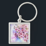 Llavero Sakura rosa sobre fondo de pintura<br><div class="desc">Dibujado artísticamente,  rama de rosa,  flores de cerezo sobre fondo pintoresco,  texturizado,  pintado con pintura blanca,  rosa y azul. Pink Sakura</div>