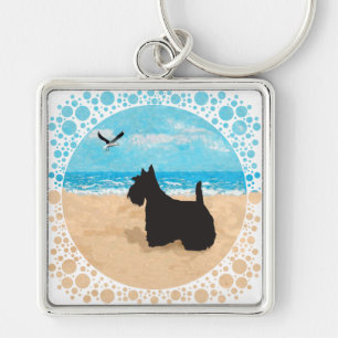 Llavero Scottie en la playa con gaviota