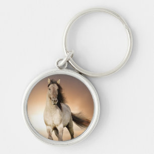 Llavero Semental salvaje que corre en puesta del sol