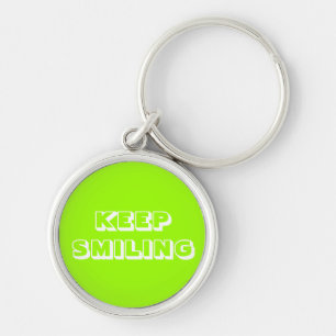 Llavero Sigue sonriendo, con caracter verde blanco