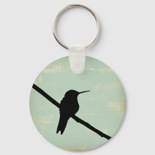 Llavero Silhouette Hummingbird con fondo azul grunge