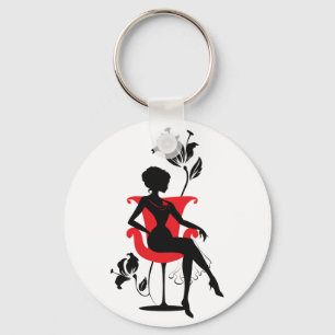 Llavero Silueta gráfica de una mujer sentada en silla roja