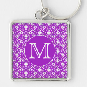 Llavero Su letra. Modelo púrpura y blanco del damasco