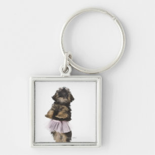 Llavero Un perrito de Yorkie-poo en un tutú en sus pierna