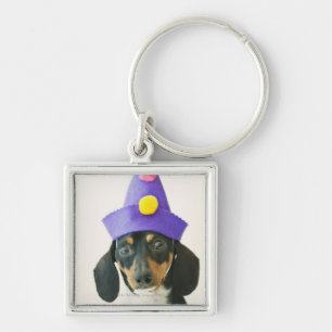 Llavero Un perro que lleva un gorra divertido