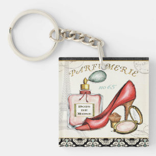 Llavero Un zapato rojo, una botella de perfume, y polvo de
