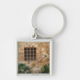 Llavero Ventana y antigua pared de piedra, Pienza, Italia
