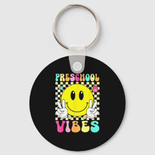 Llavero Vibraciones de preescolar cara sonriente retro de