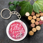 Llavero Wine a Little Laugh A Lot<br><div class="desc">La cadena de teclas de botón redondo incluye el divertido texto "Wine a Little Laugh A Lot" sobre una mancha de vino tinto. Las cadenas clave hacen regalos memorables para la familia y los amigos o crean para ustedes mismos.</div>