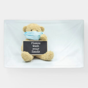 Lona El oso de peluche lleva máscara facial con las ma