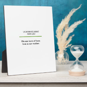 Mamás sosteniendo una placa citando a bebés en el 