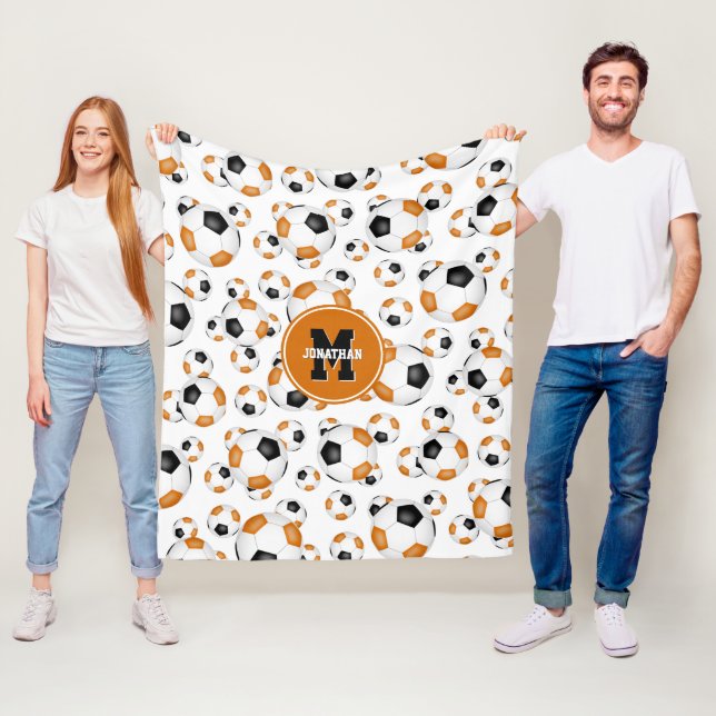 Manta Polar chica masculino en equipo negro naranja (In situ)