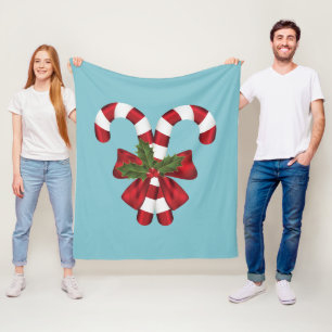 Manta Polar Dos caramelos navideños rojos y blancos sobre azul