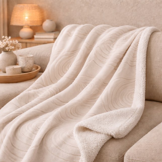 Manta Sherpa de onda de piedra Zen (Stone-inspired ripple pattern in light tan flowing across smooth ivory)