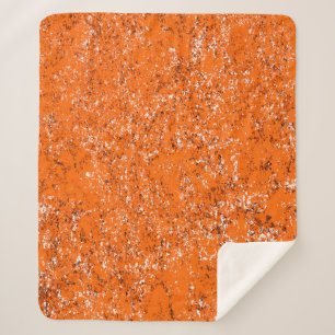 Manta Sherpa Fondo moreno oscuro. Naranja blanco negro o