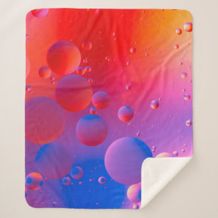 Manta Sherpa oily drops in water with colorful background, clos
