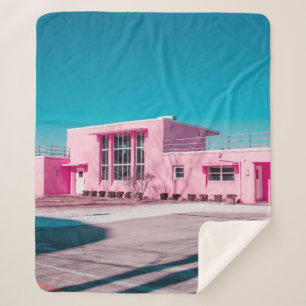 Manta Sherpa Pink concrete building under clear blue sky