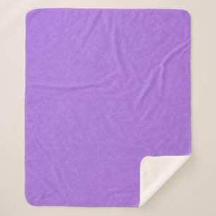 Manta Sherpa Superficie morada texturizada con patrón de remoli