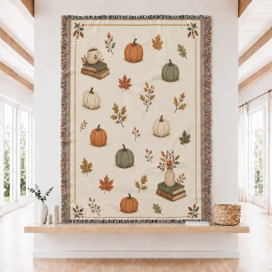 Manta tejida de calabaza y libros de otoño 