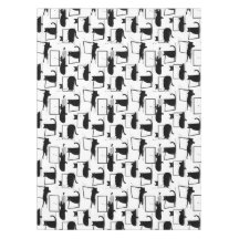 Gatos negros sentados en el patrón de las laptops