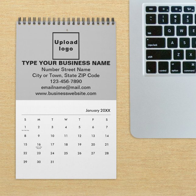 Marca comercial gris en el calendario (Build brand name awareness. Gray business branding on calendar displayed on office desk.)