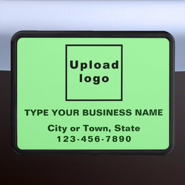 Marca comercial sobre cubierta de plástico verde c (Advertise your business while on the road. Light green business branding on plastic hitch cover.)