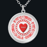 Mi primer collar de la Santa Comunión<br><div class="desc">Este collar tiene un Anfitrión rodeado de calor y con un aspecto "3-D" en el centro con el nombre de Jesús en él. En torno a todo esto están las palabras "Mi primera comunión sagrada".</div>