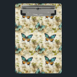 Minicarpeta De Pinza Mariposas y flores de época coloridas (1)<br><div class="desc">Disfrute de la elegancia en la palma de su mano con este portapapeles de inspiración vintage adornado con mariposas y flores de colores. No es sólo una herramienta,  es una obra de arte que mejora tus tareas cotidianas. ¡Elige los tuyos!</div>