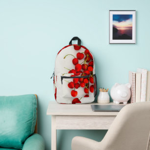 Mochila Impresa Las cerezas rojas con luz natural yacen en blanco