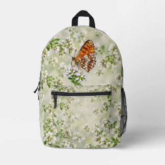 Mochila Impresa Mariposa naranja sobre delicadas flores blancas