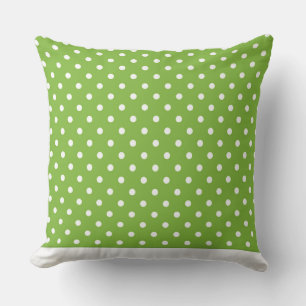 Moderna almohada de punto verde con puntos blancos