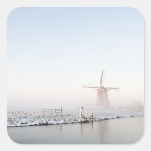 Molino de viento en la nieve en pegatina invernal