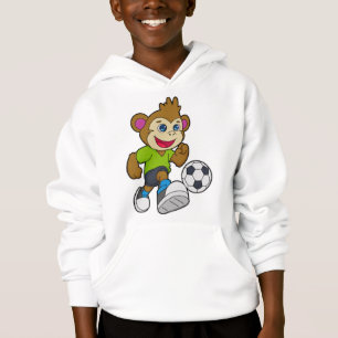 Mono como jugador de fútbol con fútbol