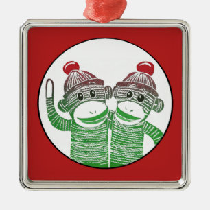 Monos del calcetín con el ornamento rojo del
