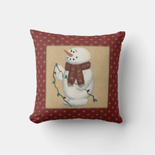 Muñeco de nieve con la almohada de las luces