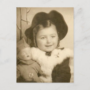 niña pequeña con postal de muñeca