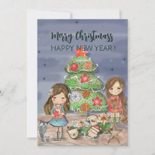 Niñas decorando árbol de Navidad