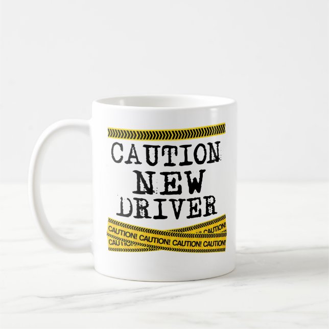 Nueva taza de café del conductor de la precaución (Izquierda)