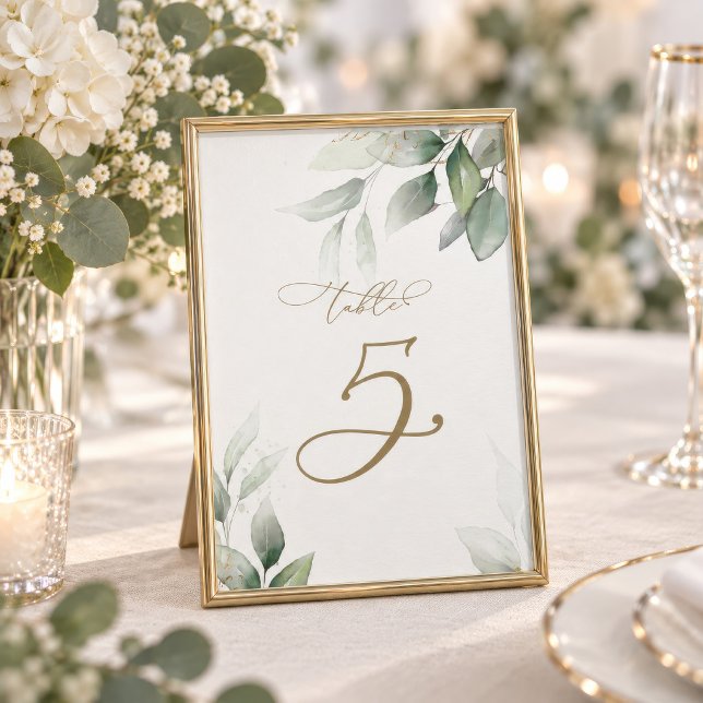 Número de mesa de boda Mesa 5 Verde de eucalipto (Eucalyptus Greenery Table Number card displayed in a gold frame with florals)