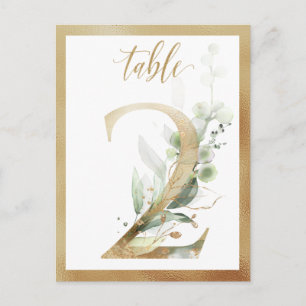 Números de mesa dorados con follaje verde, tarjeta
