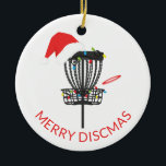 Ornamento cerámico de Navidades de Disk Golf Santa<br><div class="desc">¡Llamando a todos los amantes del golf en disco! Este adorno navideño cuenta con una cesta de golf en disco con luces de navidad, sombrero santa y un disco. El texto dice Feliz Discmas. ¡Es el regalo perfecto para ese amante del golf en su vida! Vea nuestros otros artículos de...</div>