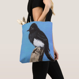 Pájaro de Phoebe negro en la bolsa de asas azul