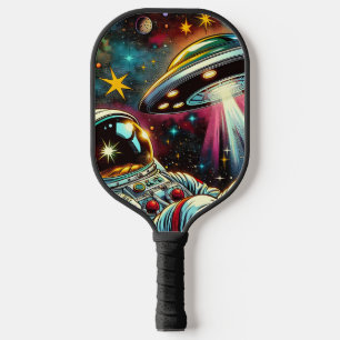 Palas De Pickleball Astronauta flotando en el espacio con un arte de O