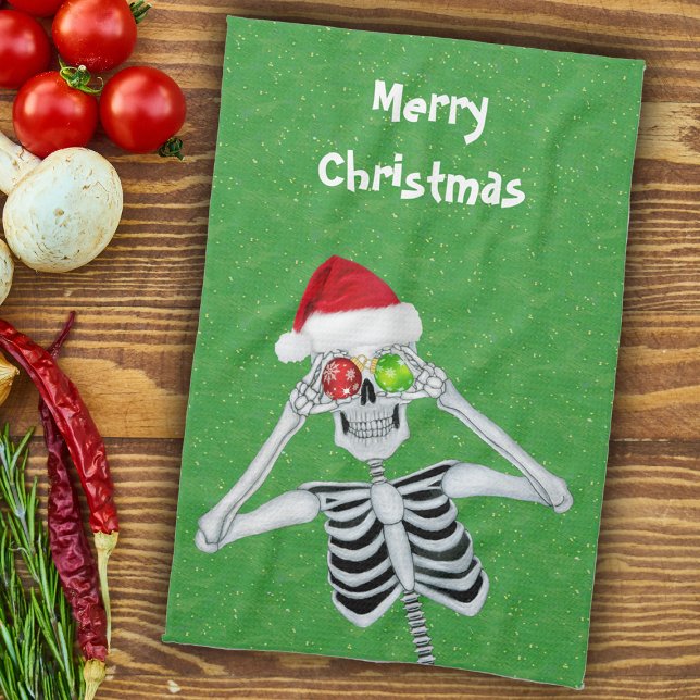 Paño De Cocina Navidades divertidos esqueletan ornamentos en verd (Fun Christmas skeleton ornament eyes Santa hat on green with gold flecks kitchen hand towel.)