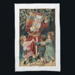 Paño De Cocina Papá Navidad con niños bailando y mistletoe<br><div class="desc">El alegre Papá Noel,  de cama roja,  sostiene su saco de regalos y está holly con tres niños felices bailando a su alrededor,  con los pimletos encima de él y los objetos de oro. El color de fondo es el personalizable.</div>